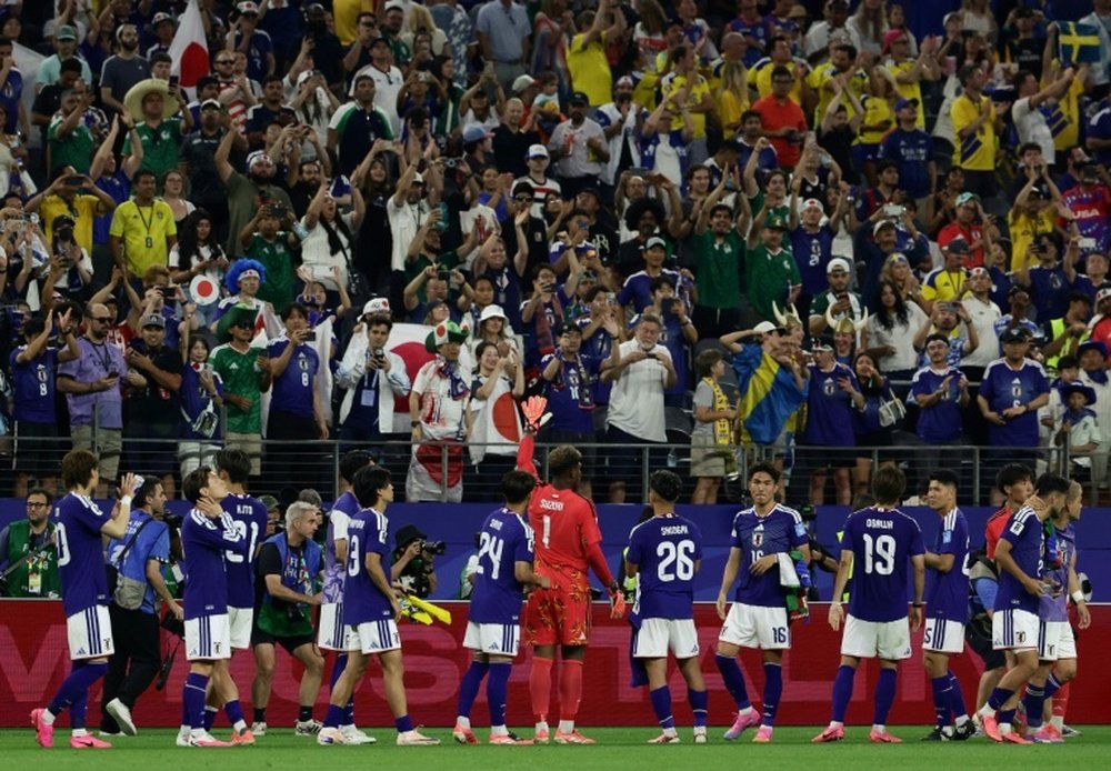 Japan's players celebrate in front of their fans AFP Aric Becker