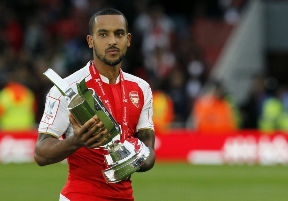 Arsenal's midfielder Theo Walcott poses with the Emirates cup after winning a pre-season friendly match against Wolfsburg at The Emirates Stadium in north London on July 26, 2015
