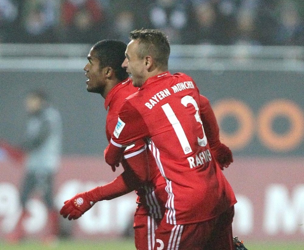 Bayern Munich midfielder Douglas Costa celebrates after scoring with Rafinha. AFP