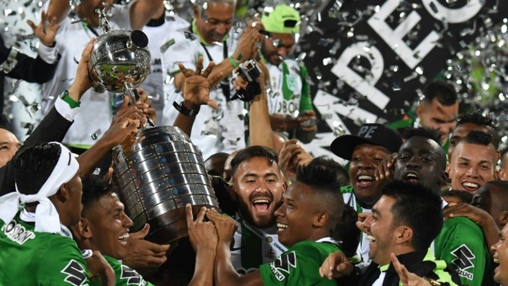 Colombias Atletico Nacional players celebrate with the trophy after winning the 2016 Copa Libertadores at Atanasio Girardot stadium