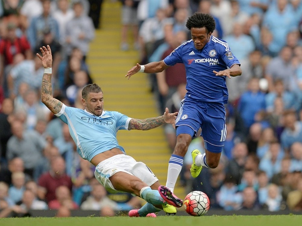 Chelseas Juan Cuadrado (R) is tackled by Manchester City defender Aleksandar Kolarov during the Premier League match at The Etihad stadium in Manchester, north-west England, on August 16, 2015