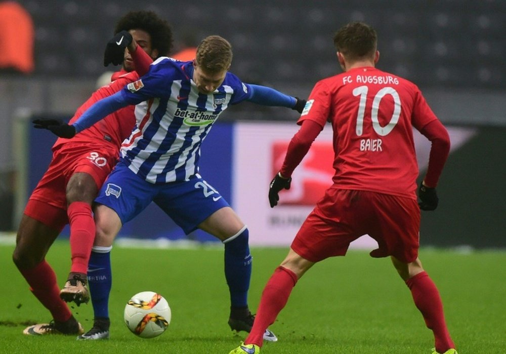 Herthas midfielder Mitchell Weiser (centre) and Augsburgs Brazilian midfielder Caiuby vie during their Bundesliga match in Berlin, on January 23, 2016