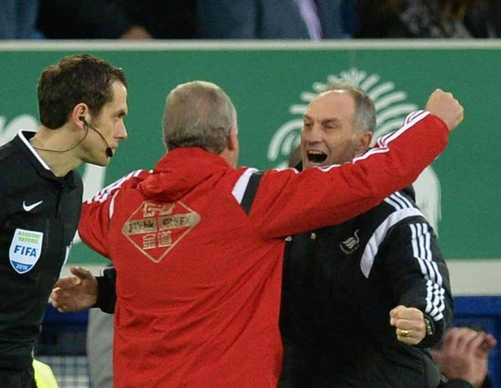 Francesco Guidolin (right) celebrates with Swanseas first team coach Alan Curtis at the final whistle against Everton at Goodison Park on January 24, 2016