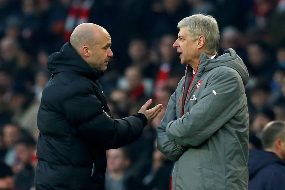 Arsenals Arsene Wenger was shown pushing FA official Taylor after he was sent off a match. AFP