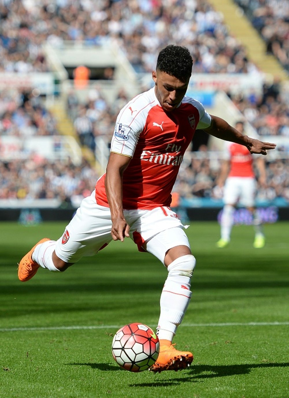 Arsenal's English midfielder Alex Oxlade-Chamberlain takes a shot which deflected in for Arsenal's opening goal in the English Premier League football match between Newcastle United and Arsenal in Newcastle-upon-Tyne, England, on August 29, 2015