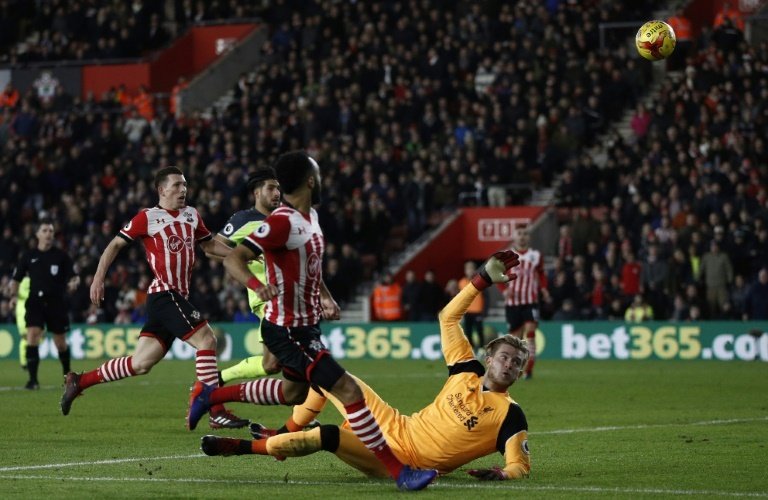 Southamptons Nathan Redmond (C) chips the ball over Liverpools goalkeeper Loris Karius during their EFL (English Football League) Cup semi-final first-leg match, at St Marys Stadium in Southampton, on January 11, 2017
