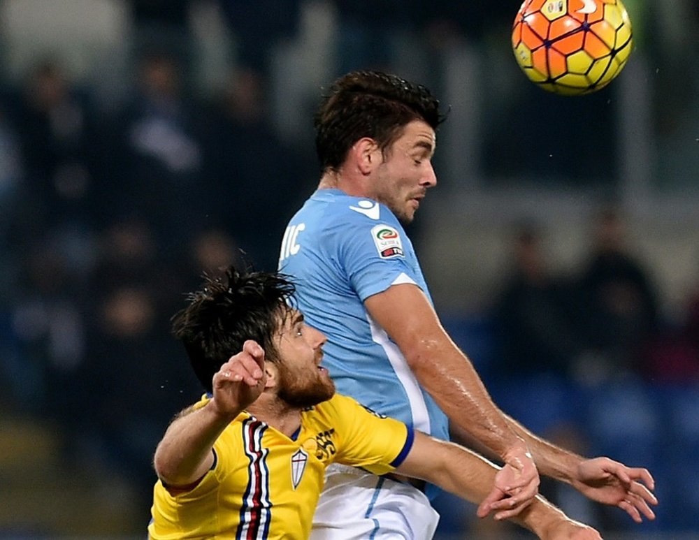 Lazios forward Filip Djordjevic (R) heads the ball with Sampdorias defender Ervin Zukanovic during an Italian Serie A football match at the Olympic Stadium in Rome on December 14, 2015