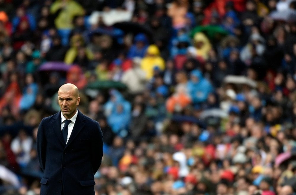 Real Madrids coach Zinedine Zidane looks on during the Spanish league football match against Athletic Bilbao at the Santiago Bernabeu stadium in Madrid on February 13, 2016