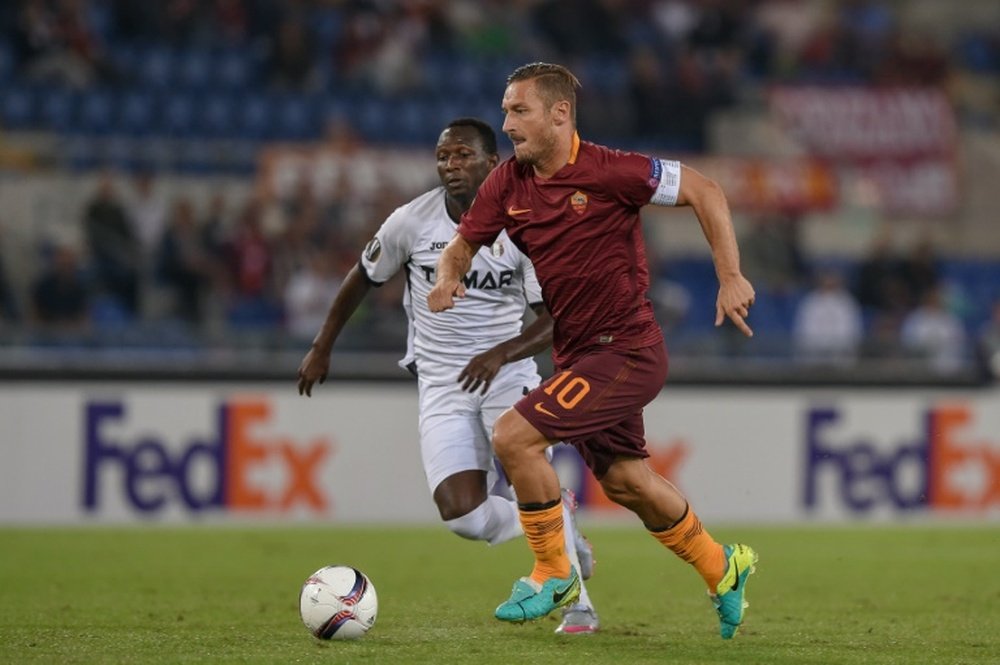 Totti runs with the ball in a match for Roma. AFP