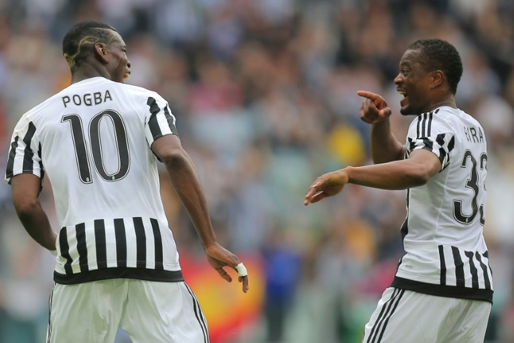 Juventus midfielder Paul Pogba (L) celebrates after scoring with teammate and fellow Frenchman Patrice Evra during the Italian Serie A match against Palermo at the Juventus stadium in Turin on April 17, 2016