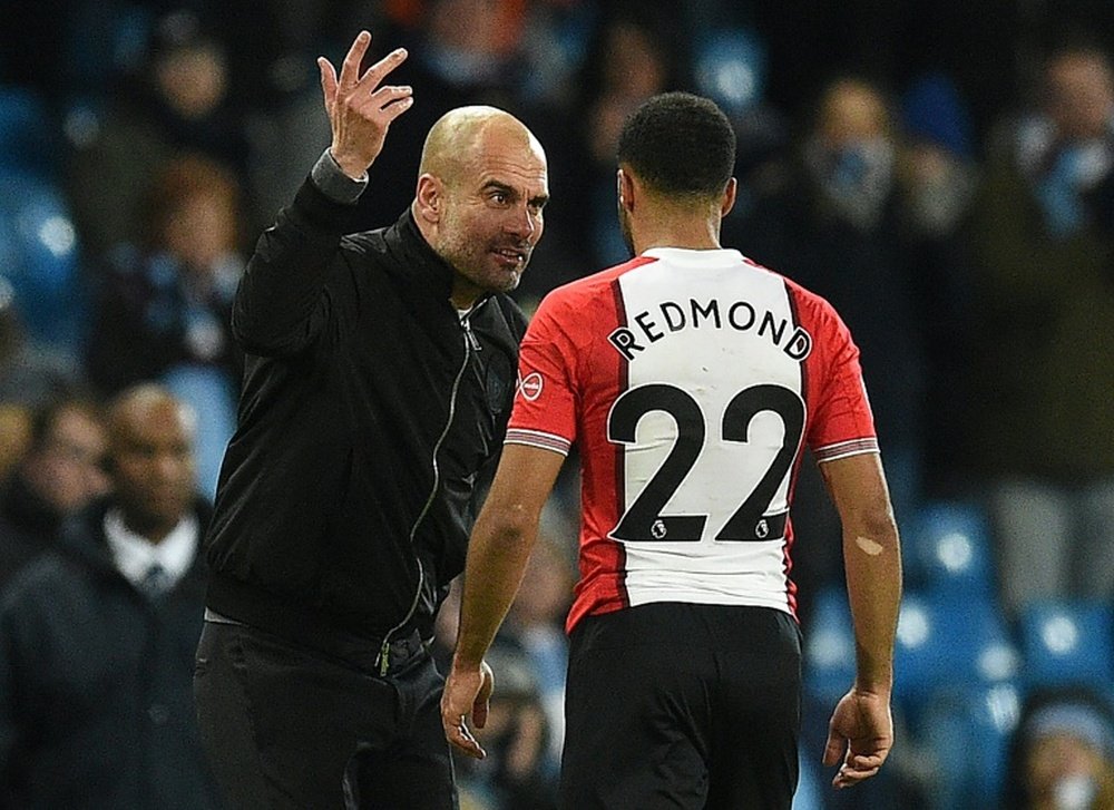 Guardiola regrets his on-field conversation with Redmond. AFP