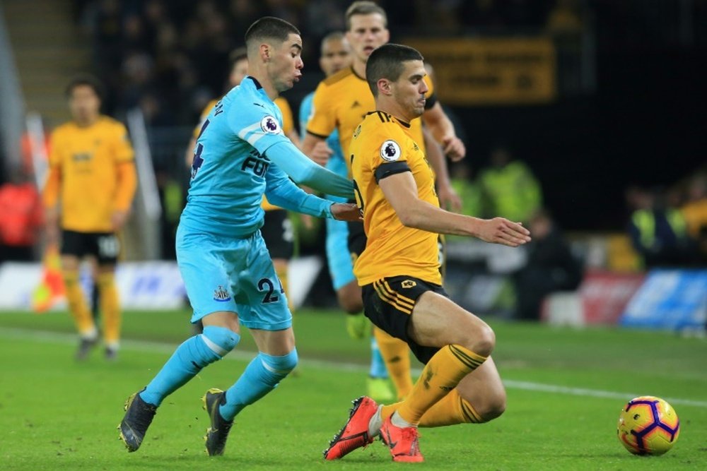Newcastle's Miguel Almiron challenges Wolves' Conor Coady. AFP