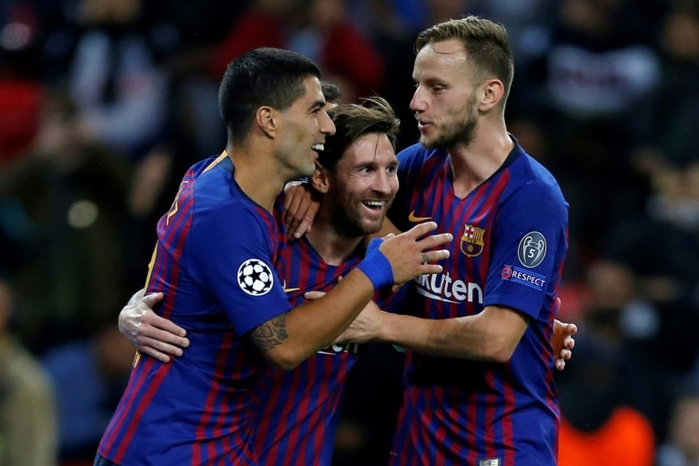 Lionel Messi celebrates his goal with Luis Suárez and Ivan Rakitic. AFP