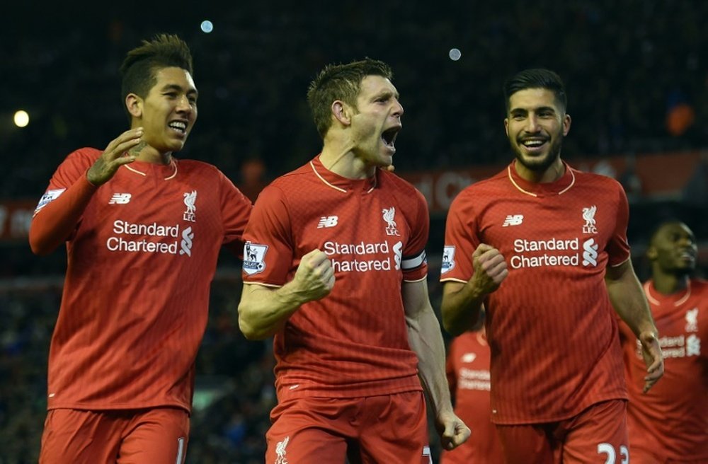 Liverpools James Milner (C) celebrates with teammates Roberto Firmino and Emre Can (R) after scoring a goal from the penalty spot during their English Premier League match against Swansea City, at Anfield in Liverpool, on November 29, 2015