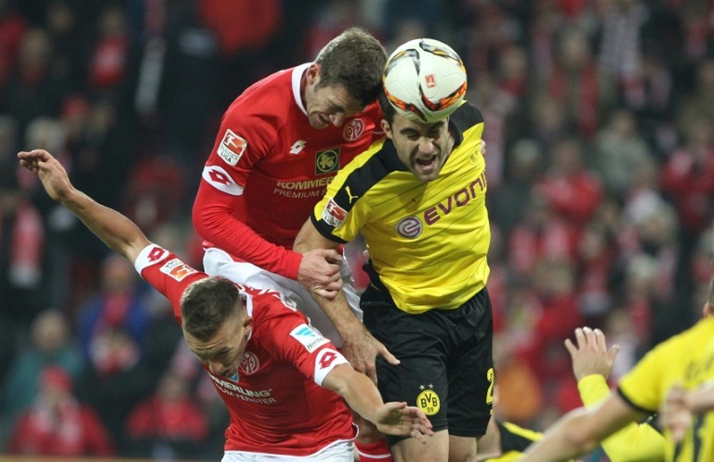 Dortmunds Greek defender Sokratis (R) and Mainz defender Stefan Bell (top, L) vie for the ball during the German first division Bundesliga football match in Mainz, western Germany, on October 16, 2015