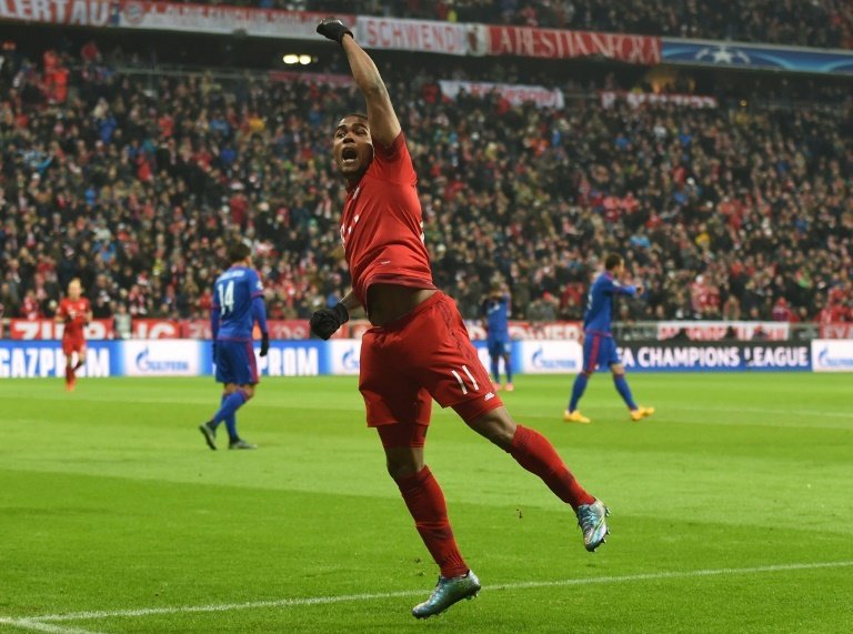 Bayern Munichs midfielder Douglas Costa celebrates after his goal during the UEFA Champions League Group F football match between FCB Bayern Munich and Olympiakos Piraeus on November 24, 2015 at the Allianz Arena in Munich