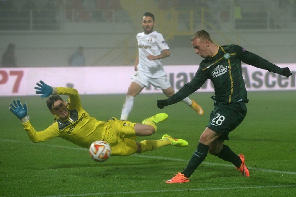 Leigh Griffiths (R) scored the first goal for Celtic after the champions were awarded a penalty four minutes into the match against Ross County, as the new season of the Scottish Premiership got underway