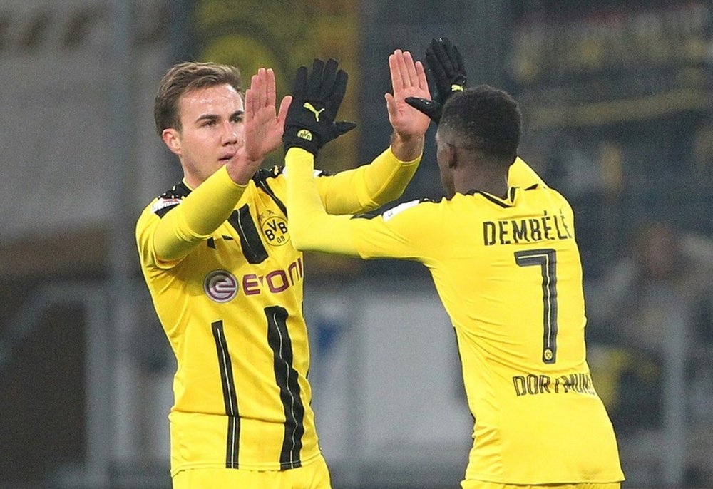Dortmunds midfielder Mario Goetze celebrates scoring the 1-1 with Dortmunds midfielder Ousmane Dembele during the Bundesliga football match against Hoffenheim December 16, 2016