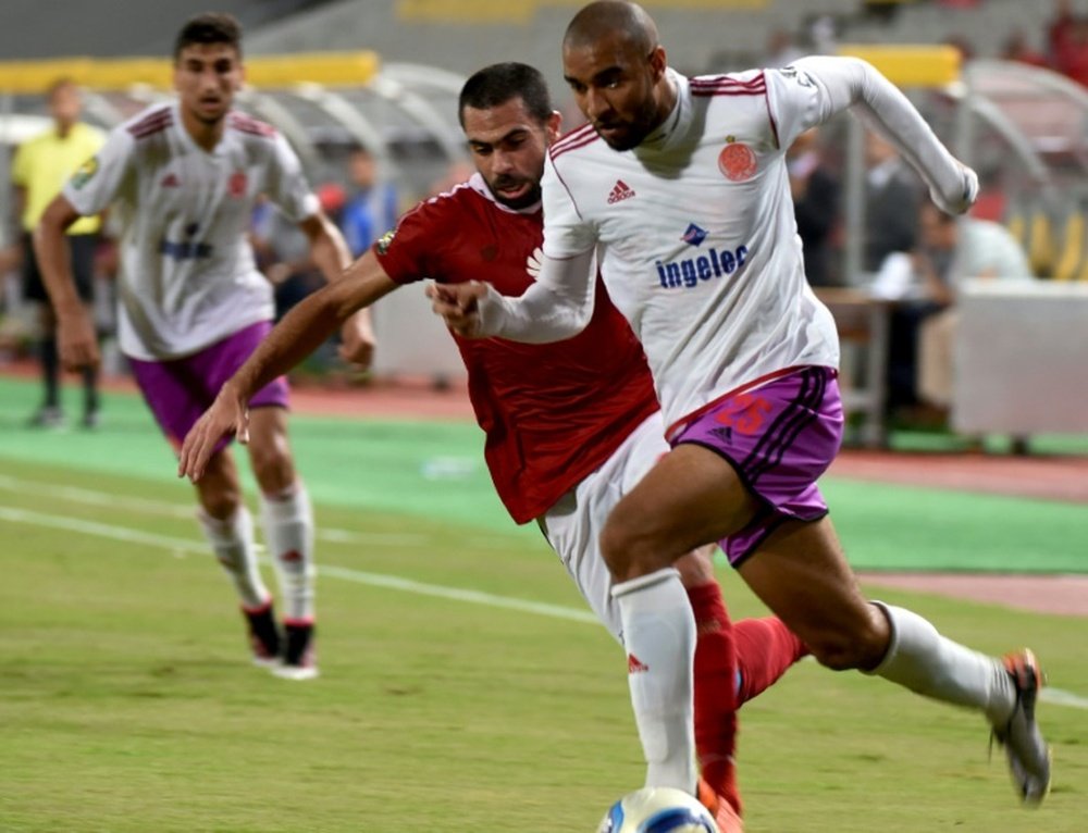 Al-Ahlys Ahmed Fathi (L) marks Wydads Ismail El Haddad during their CAF Champions League match. AFP