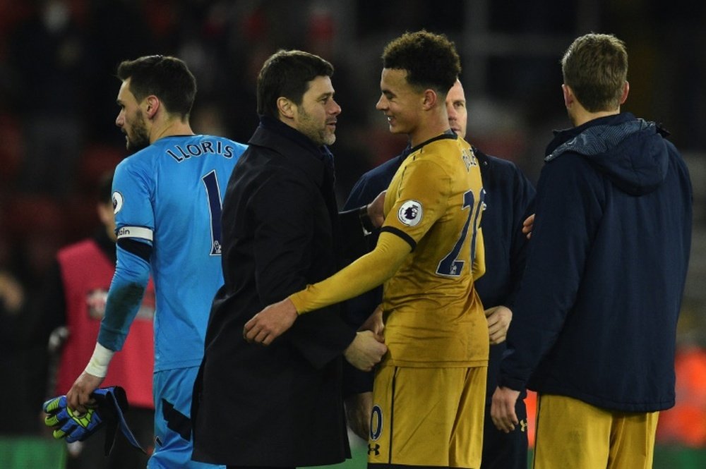 Alli (R) shakes the hand of manager Mauricio Pochettino after Spurs' win over Southampton. AFP
