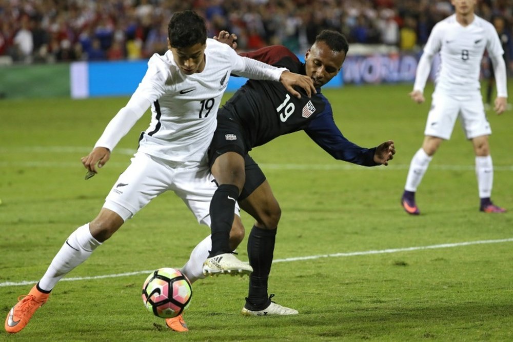 Julian Green (R) of the US fights for the ball with Moses Dyer of New Zealand during their intl friendly at RFK Stadium in Washington, DC, on October 11, 2016