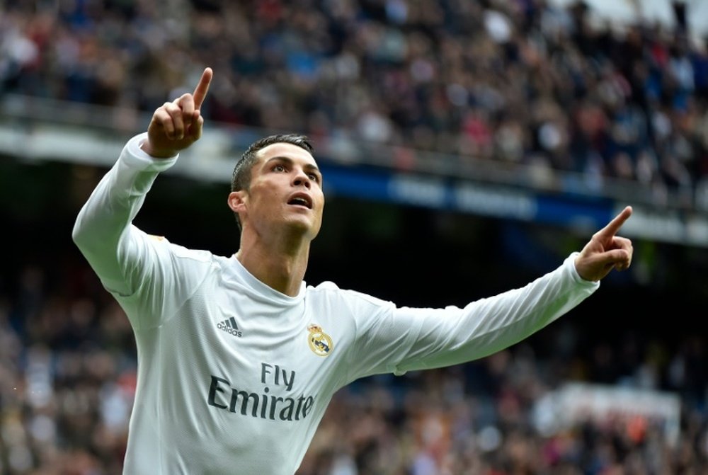 Real Madrids forward Cristiano Ronaldo celebrates after scoring during the Spanish league match Real Madrid vs Athletic Bilbao at the Santiago Bernabeu stadium in Madrid on February 13, 2016