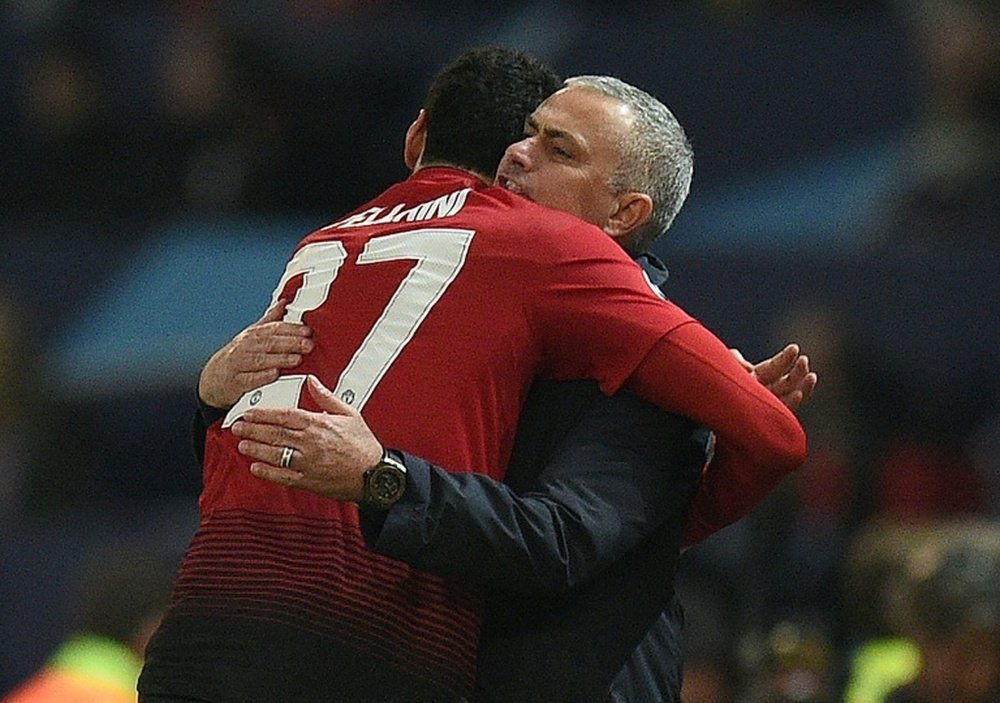 Fellaini and Mourinho celebrate the late winner. AFP