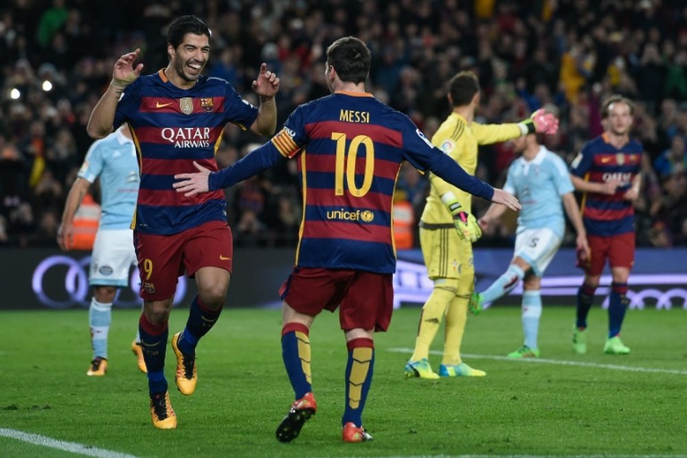 Barcelonas forward Luis Suarez (L) celebrates his goal with forward Lionel Messi during a Spanish league football match against Celta de Vigo at the Camp Nou stadium in Barcelona on February 14, 2016
