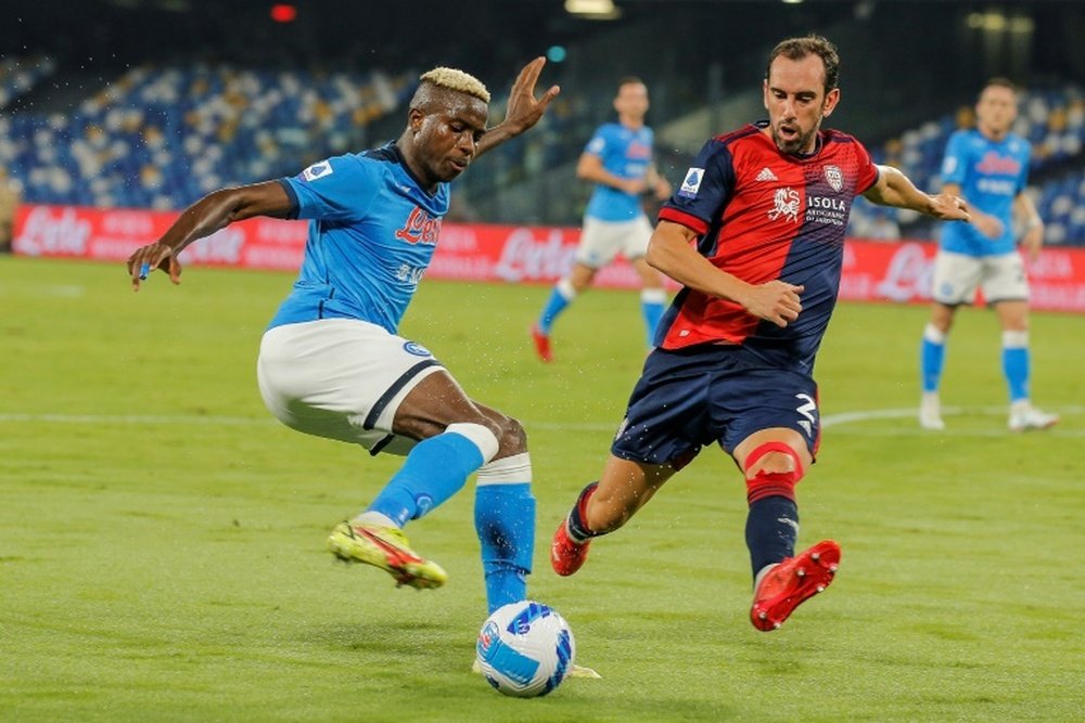 Napoli forward Victor Osimhen (L) is challenged by Cagliari defender. AFP