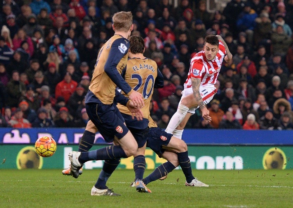 Stoke Citys Mato Joselu (R) attempts an unsuccessful shot on goal during an English Premier League match against Stoke City in England on January 17, 2016