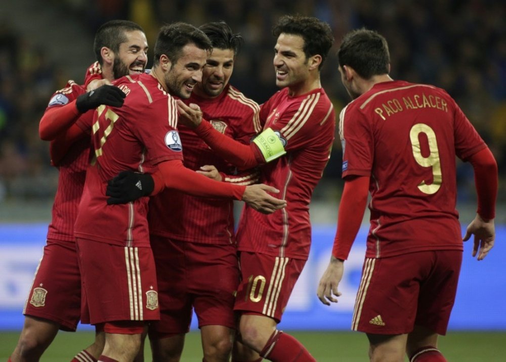 Spains players celebrate after scoring during the Euro 2016 qualifying football match against Ukraine at Olympiysky stadium in Kiev on October 12, 2015