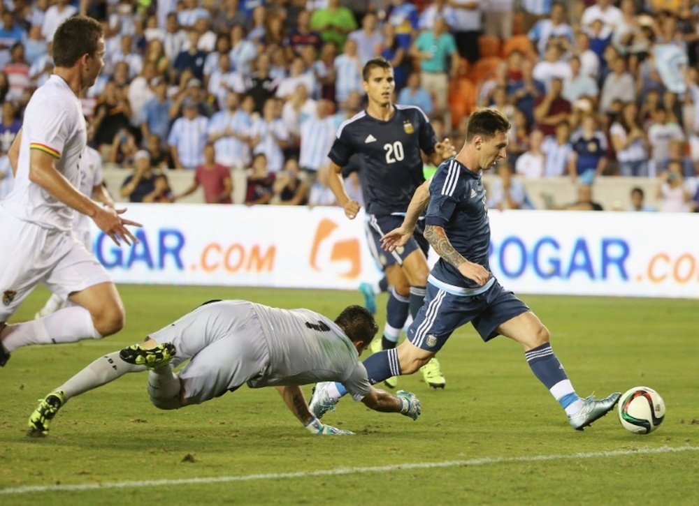 Lionel Messi of Argentina scores a goal past Dainel Vaca of Bolivia during their international friendly match at BBVA Compass Stadium on September 4, 2015 in Houston, Texas
