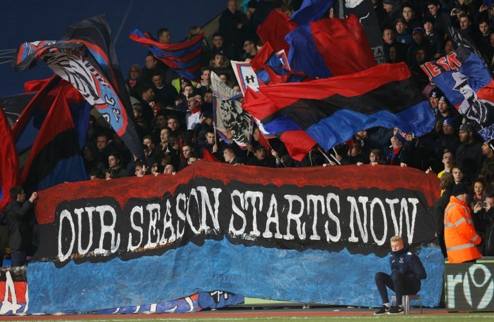 Crystal Palace fans hold a banner during aPremier League football match at Selhurst Park. BeSoccer