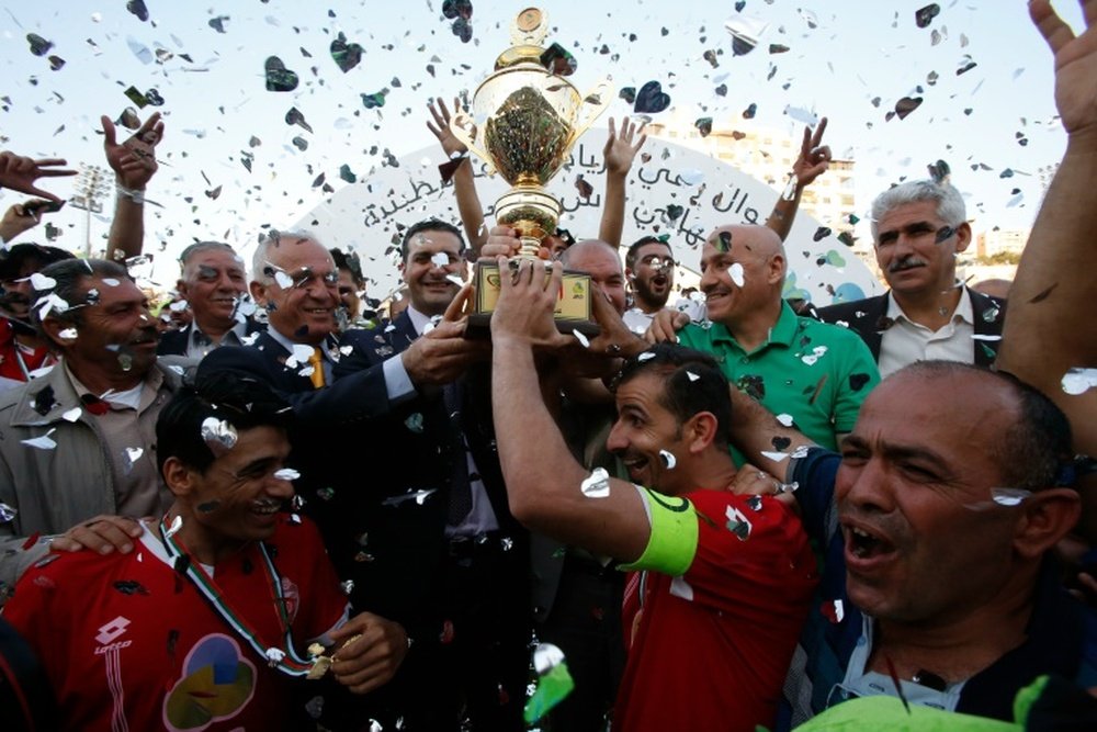 Players of Hebrons Ahly al-Khalil football club celebrate with the Palestinian Cup. AFP