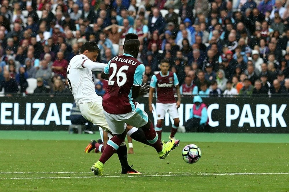 Watfords midfielder José Holebas (L) scores his teams fourth goal during the English Premier League football match against West Ham United on September 10, 2016