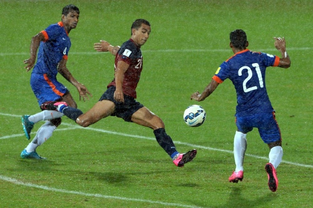 Guam forward Marcus Lopez is challenged by Indias Narayan Das (right) and Arnab Kumar Mondal during their Asia Group D 2018 World Cup qualifying match in Bangalore on November 12, 2015