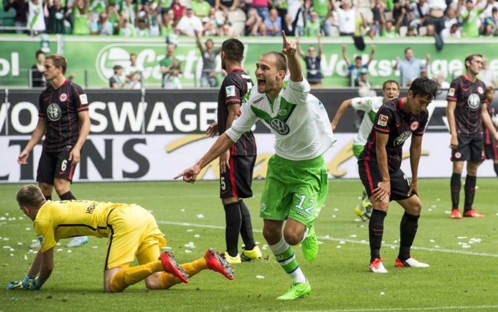 Wolfsburgs striker Bas Dost celebrates after scoring his sides second goal during the Bundesliga match against Eintracht Frankfurt in Wolfsburg on August 16, 2015
