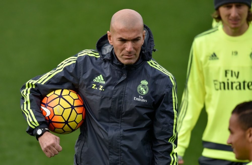 Real Madrids new French coach Zinedine Zidane holds a ball during a training session at the at Valdebebas training ground in Madrid on January 8, 2016