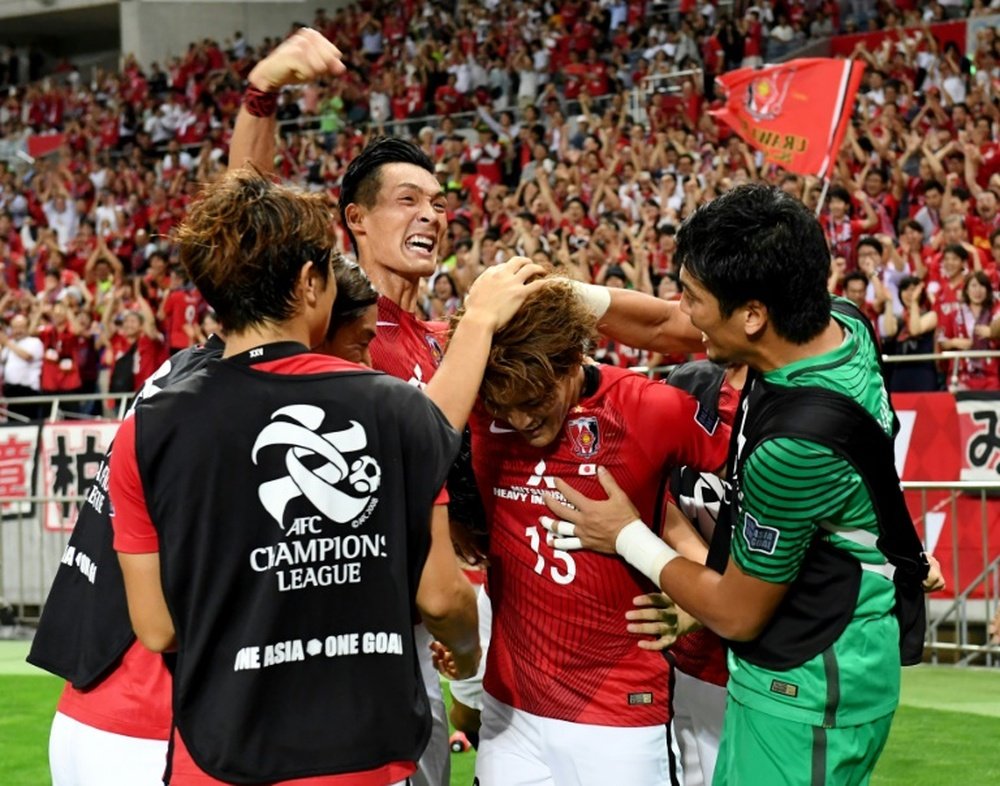 Forward Toshiyuki Takagi celebrates after scoring. AFP