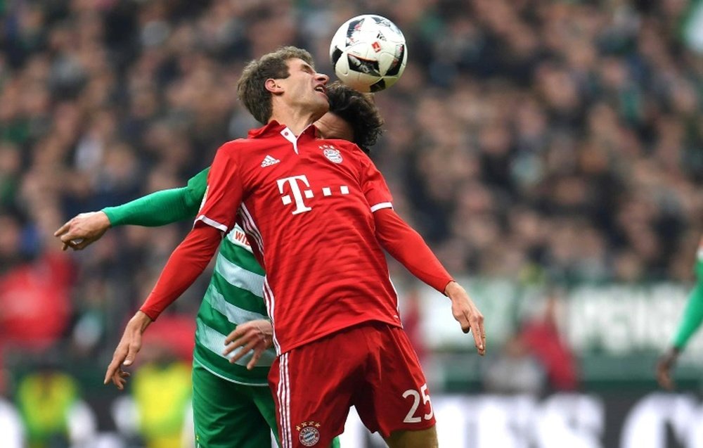 Bremen's Thomas Delaney and Bayern Munich's Thomas Mueller try to head the ball. AFP