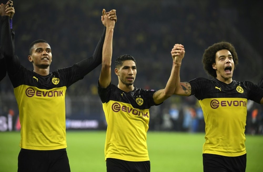 Achraf (C) is having a great season at Dortmund and he could well return to Real Madrid. AFP
