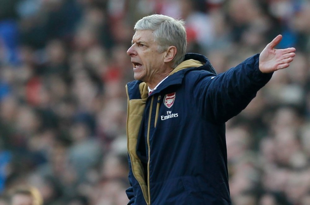 Arsenals manager Arsene Wenger reacts on the touchline as his team try to come back from two goals down in the FA Cup quarter final football match between Arsenal and Watford at the Emirates Stadium in London on March 13, 2016