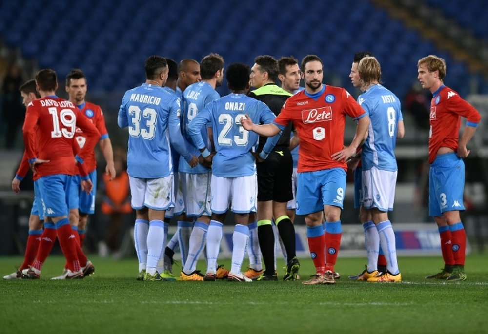 Referee Massimiliano Irrati (C) suspends the game for a few minutes because of racist chants by Lazios supporters during the Italian Serie A football match Lazio vs Napoli on February 3, 2016 in Rome