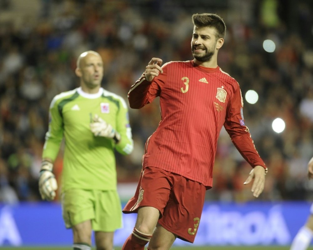 Spains defender Gerard Pique (R) grimaces during the Euro 2016 qualifying football match Spain vs Luxembourg at Las Gaunas stadium in Logrono on October 9, 2015