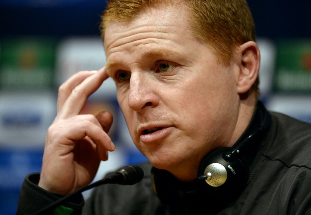 Neil Lennon was struck by objects thrown by the crowd. AFP
