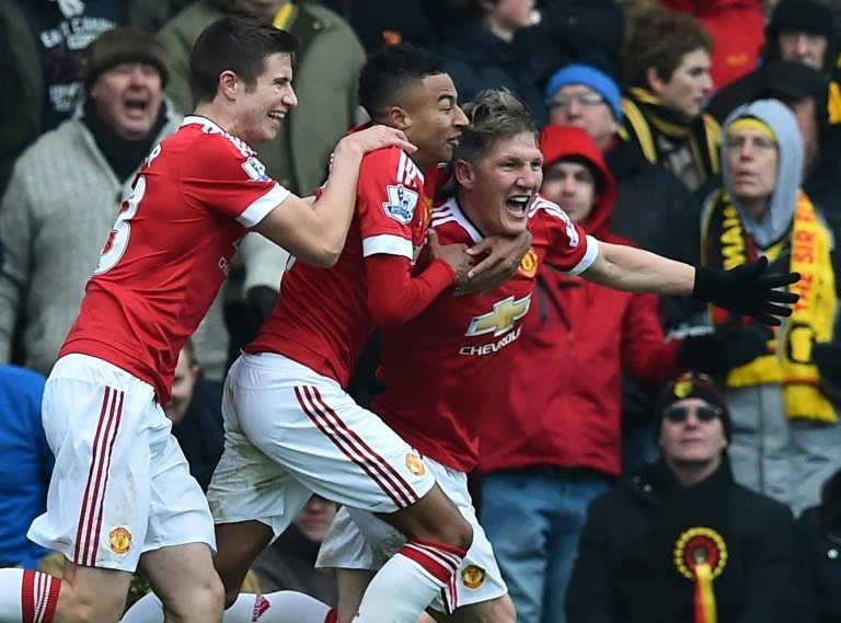 Manchester Uniteds Bastian Schweinsteiger (R) celebrates with teammates Paddy McNair and Jesse Lingard (2nd L) after scoring during the Premier League match against Watford at Vicarage Road Stadium on November 21, 2015