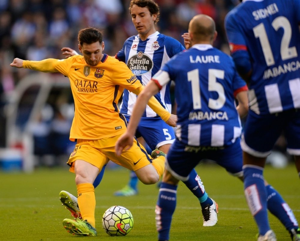 Barcelona forward Lionel Messi (L) is tracked by Deportivo La Coruna players during the Spanish league match at the Municipal de Riazor Stadium in La Coruna on April 20, 2016