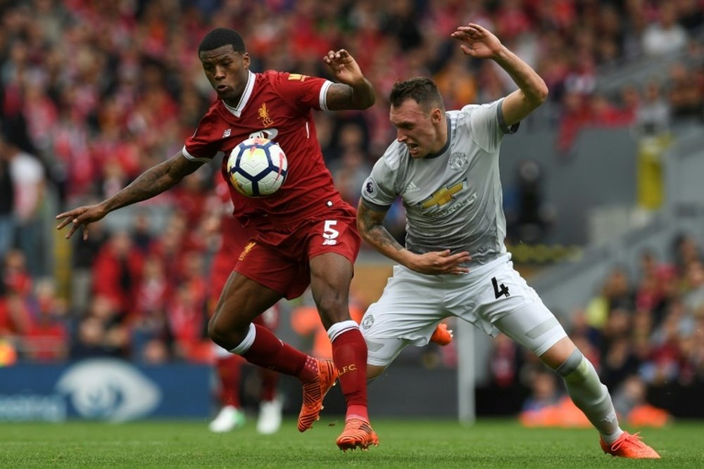 Wijnaldum and Jones fight for the ball in the heavyweight matchup. AFP