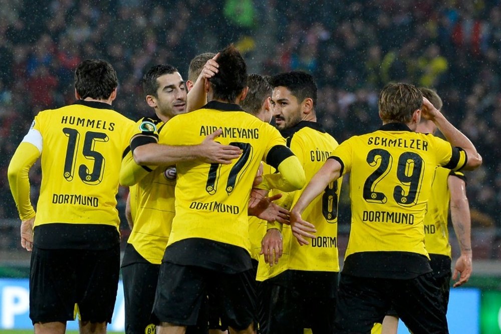 Dortmund players celebrate after they score the opening goal during the German Cup quarter final football match at VfB Stuttgart on February 9, 2016