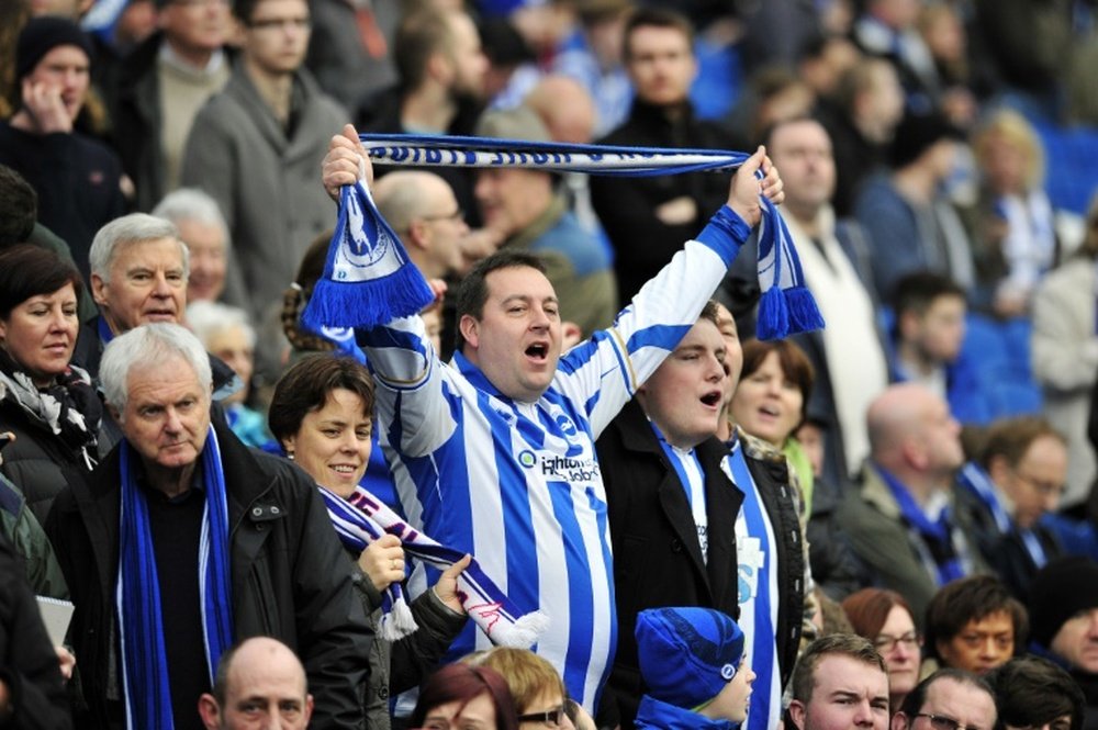 Brighton & Hove Albions fans singing in the crowd ahead of the English FA Cup third round football match between Brighton & Hove Albion and Newcastle United in Brighton, southern England on January 5, 2013